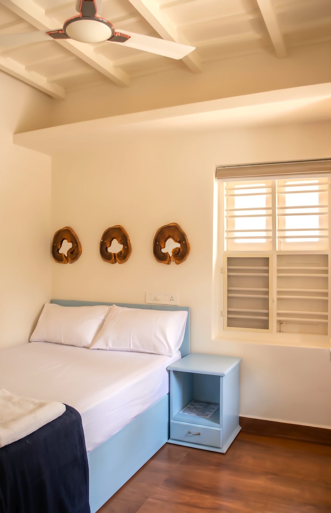 Bedroom with a soft blue headboard and side table