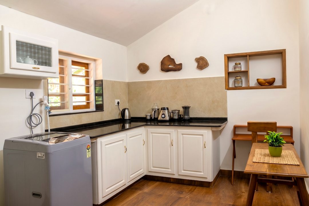 Second counter with a kettle, small wooden table and utility corner